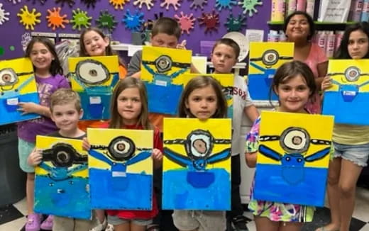 a group of children holding up cartoon characters