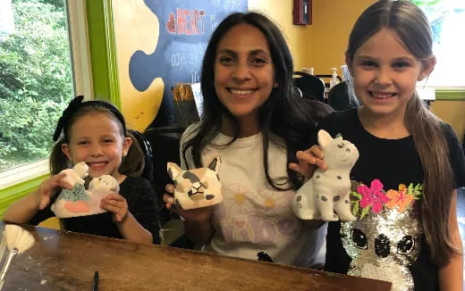 a group of women holding stuffed animals