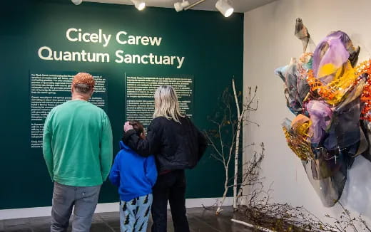 a group of people looking at a sign