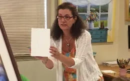 a woman holding a piece of paper
