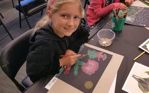 a girl painting on a table