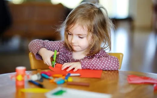 a girl coloring on a paper