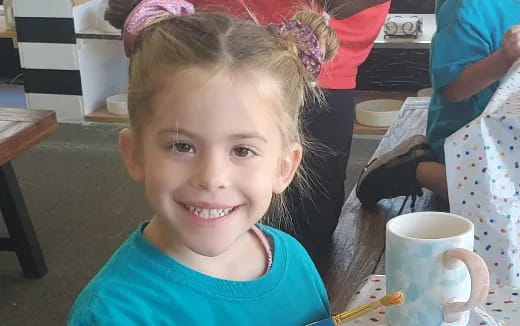 a child smiling at the camera