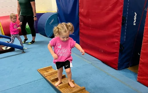 a child standing on a wooden platform