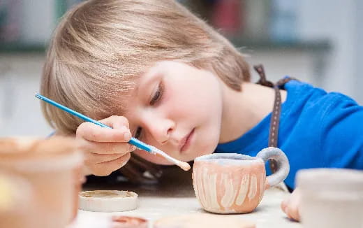 a young boy with a spoon in his mouth