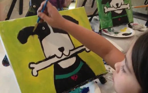 a child painting a cake