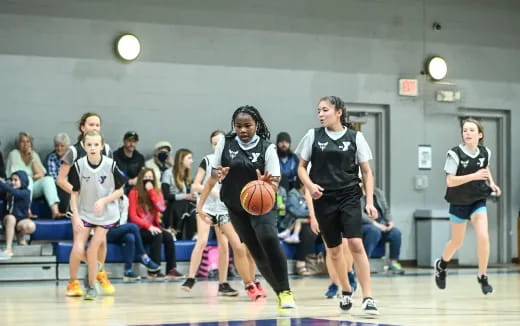 a group of people playing basketball