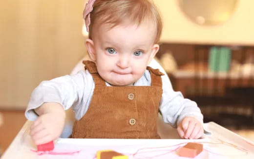 a baby sitting at a table