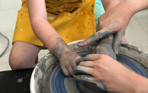 a person holding a bucket of dirt