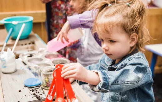 a young girl playing with a toy