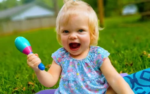 a baby holding a toy