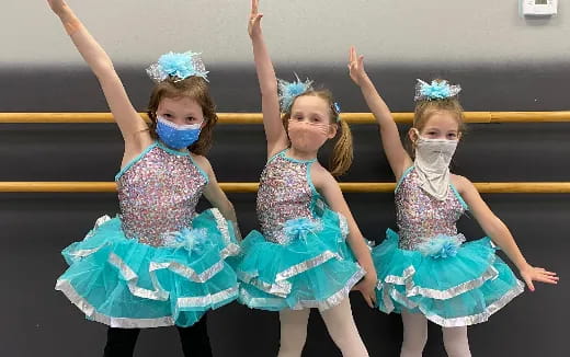 a group of girls in blue dresses