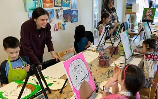 a person and children in a classroom