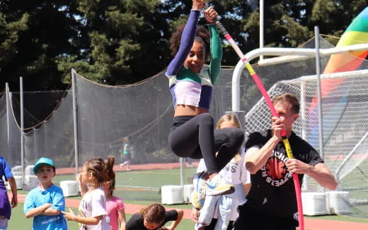 a girl jumping in the air with a girl in the air