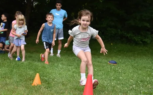 a group of kids playing with frisbees