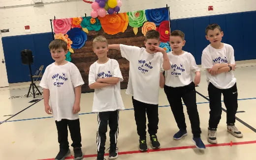 a group of kids in white shirts