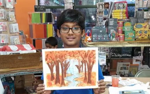 a boy holding a picture of a boy