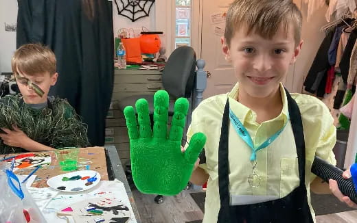 a boy wearing green gloves