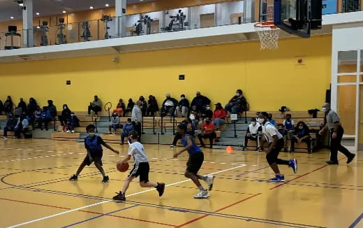 a group of people playing basketball