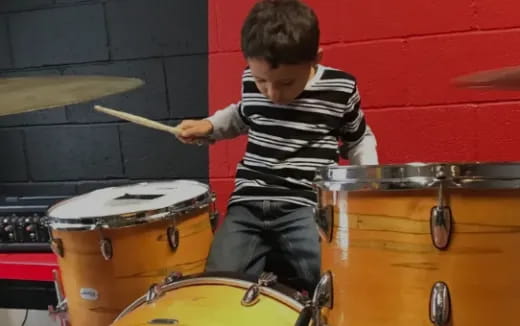 a boy playing drums