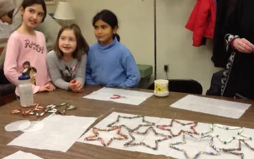 a group of women sitting at a table with a board game
