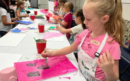 a girl painting on a table