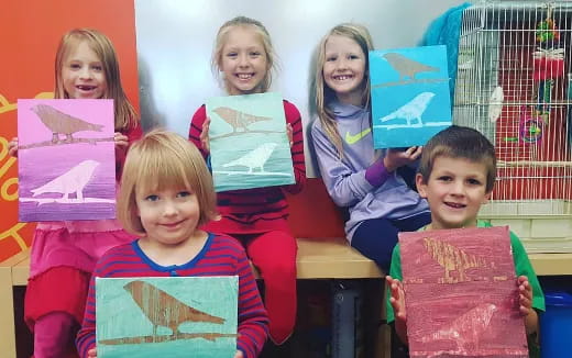 a group of children holding books