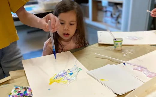 a child painting on a table