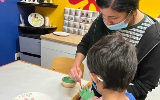 a man and a boy painting