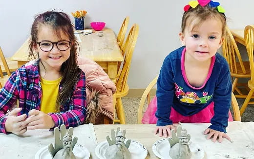 a couple of children sitting at a table