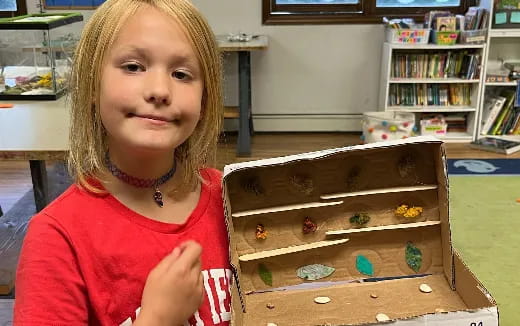 a girl holding a box