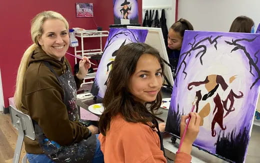 a couple of girls holding a drawing