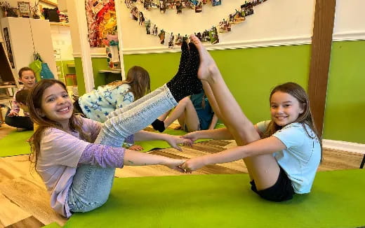 a group of girls doing yoga