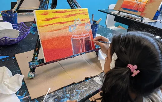 a child painting on a table