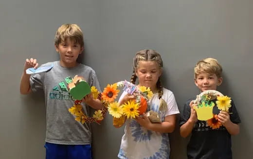 a group of children holding flowers
