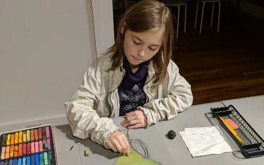 a girl sitting at a table