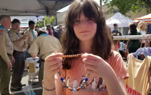 a woman holding a small insect