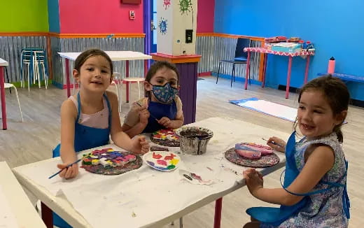 a group of girls eating at a table
