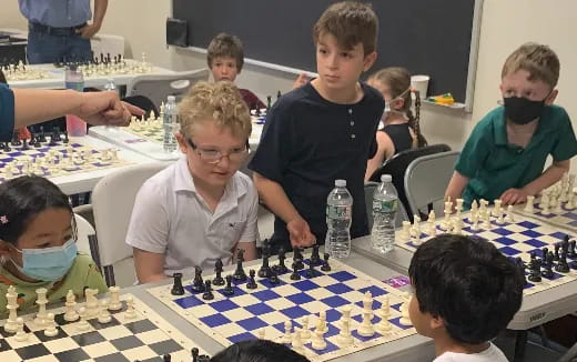 a group of people playing chess