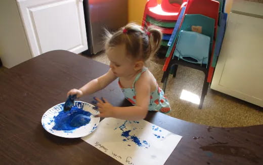 a little girl eating cake