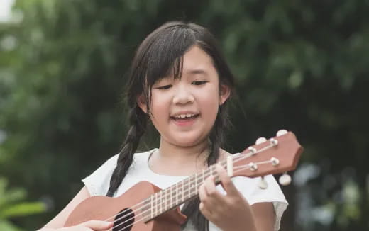 a girl playing a guitar