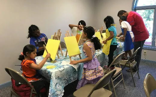 a group of children painting
