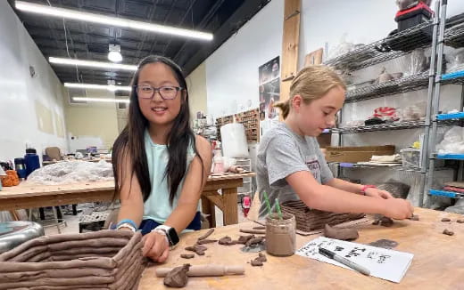 a person and a boy in a workshop