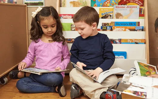 a boy and girl reading a book