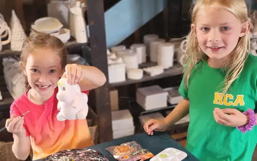 a couple of girls making doughnuts