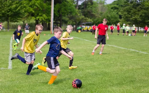a group of kids playing football