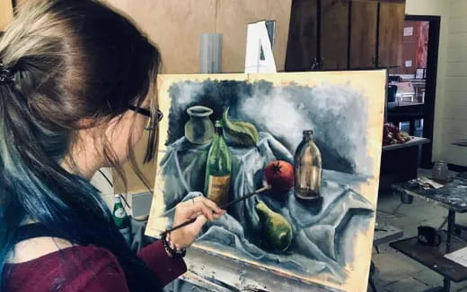 a woman painting a picture