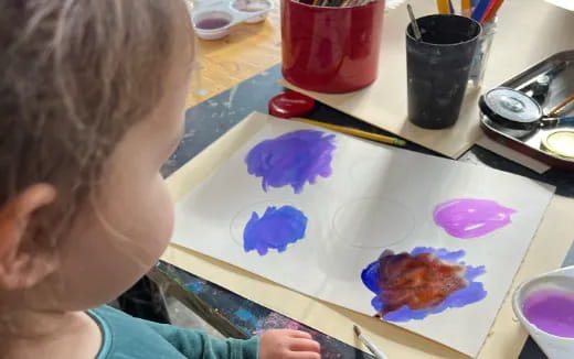 a child painting on a table