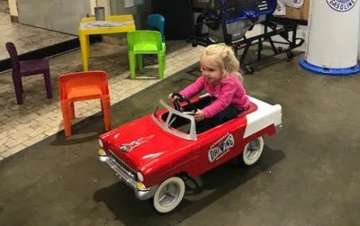 a child in a toy car