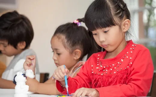 a group of children sitting at a table